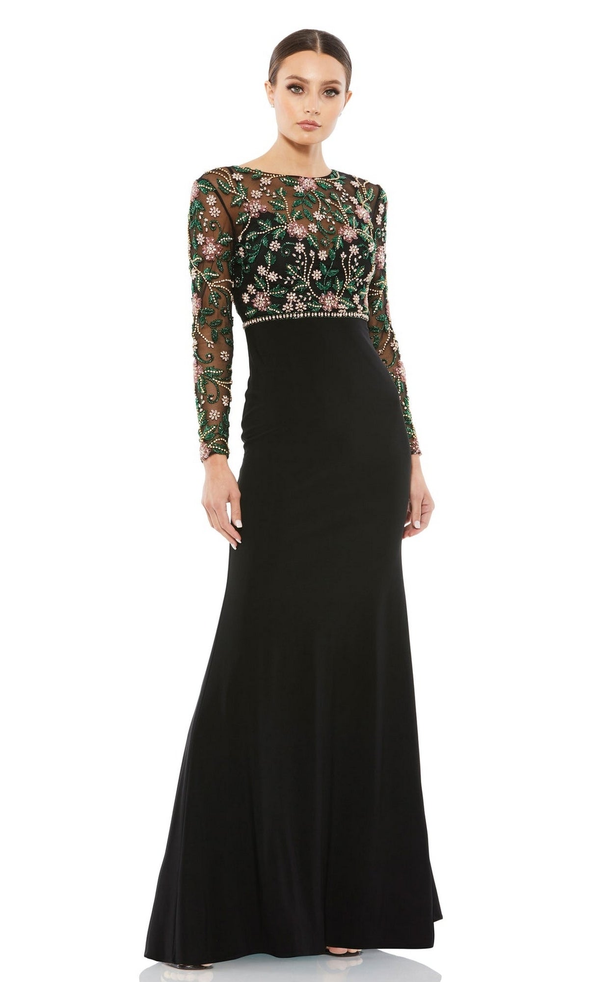 A woman faces forward in the Mac Duggal 67870 long sleeve black formal dress featuring a beaded bodice and sheer embroidered sleeves, ideal as a sophisticated mother of the bride gown.